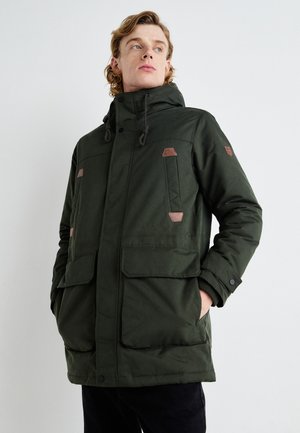 Green insulated parka with a hood, featuring chest and side pockets, brown leather accents, and a zip closure. Smooth textured fabric.