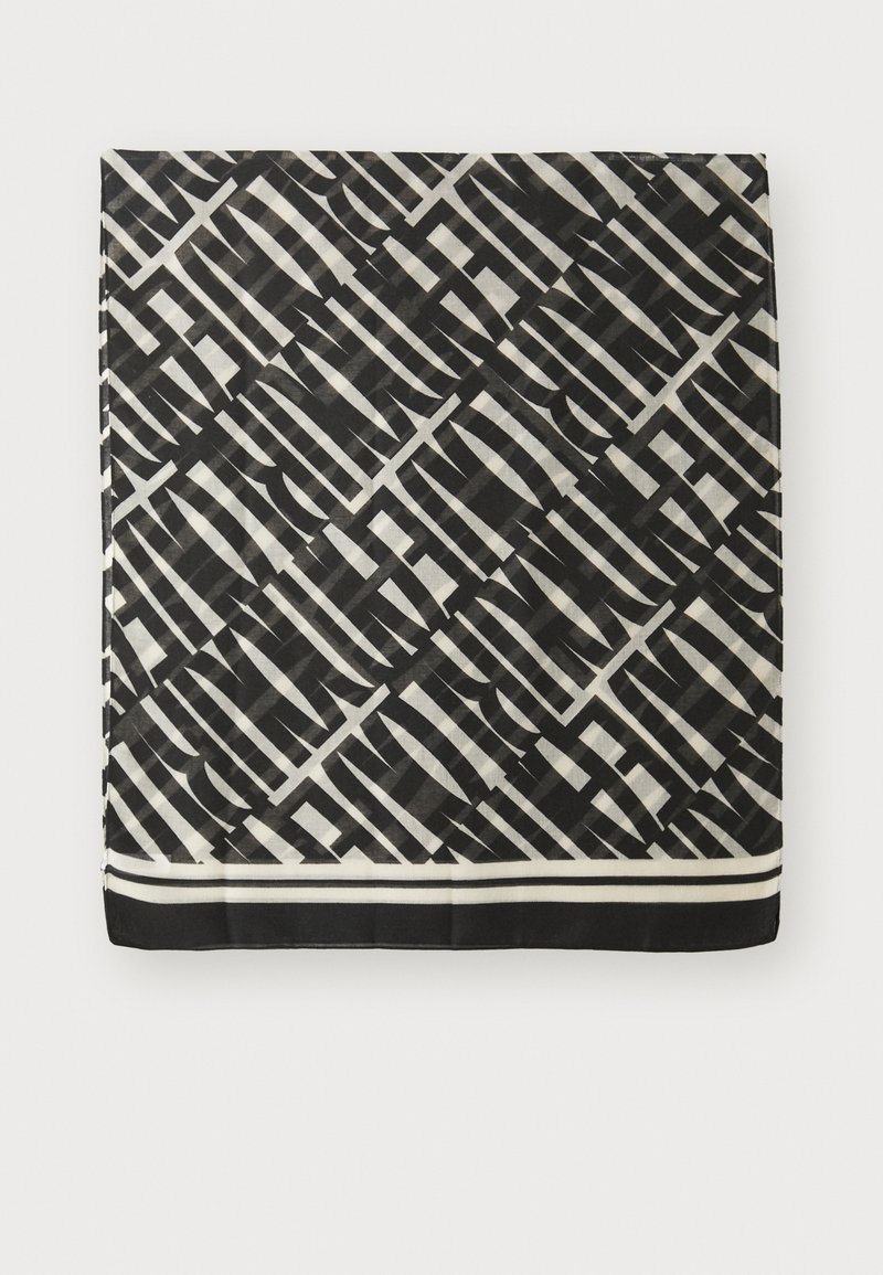 Eșarfă cu un model alb-negru, având un design geometric cu dungi contrastante și o margine solidă neagră în partea de jos.