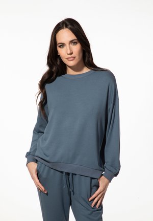 Losse, langslijf sweatshirt met lange mouwen in gedempt turquoise, met een ronde hals, ribgebreide manchetten en zoom. Zacht, gestructureerd stof voor comfort.