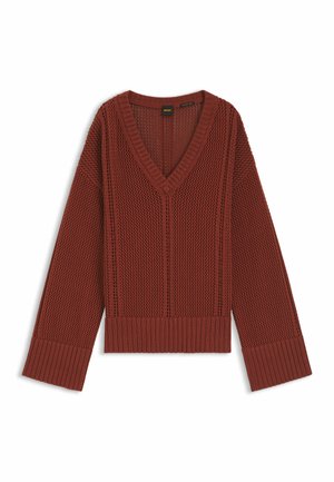 Ruosteen värinen neulepaita, jossa V-kaulus, teksturoidulla kuviolla, resorireunuksilla hihansuissa ja helmassa, aseteltu tasaiselle valkoiselle taustalle.