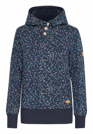 Sweatshirt navy avec un design à motifs en points beige et bleu clair. Il dispose d'un col montant, de trois boutons en bois et de poignets côtelés.