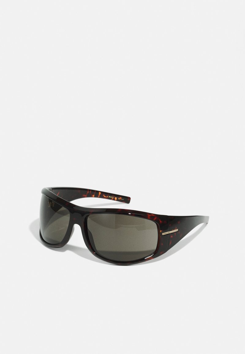 Dark tinted rectangular sunglasses with tortoiseshell frame and gold accent on the side, angled on a white background.