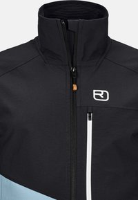 Black jacket with high collar, zippered front, and contrasting blue panel. Features white zipper and logo on chest. Soft, textured material.