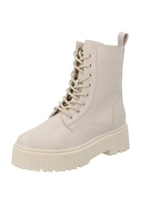 Botines beige con cordones, hechos de cuero suave, con una suela gruesa y estriada y una pestaña en la parte posterior para ponérselos fácilmente.