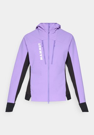 Lys lilla softshell-jakke med sorte sidepaneler, tommelhull på ermene, frontglidelås, brystlommer med glidelås og vertikal "MAMMUT"-logo på venstre side.