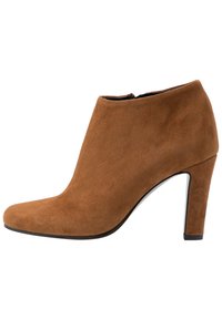 Brun ruskindsankelstøvle med spids tå, slank høj hæl og glat finish. Har en sidelukning for nem påtagning.