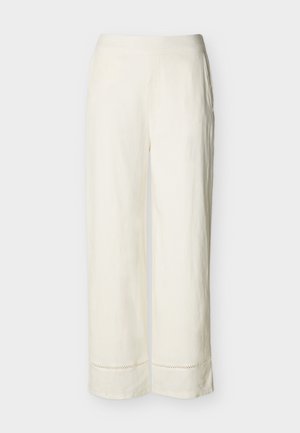 Women's loose-fit, ankle-length cream pants with wide legs and subtle decorative stitching near the hem.