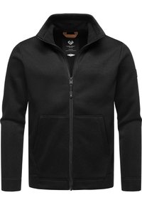 Felpa nera con zip e colletto alto, due tasche laterali, tessuto testurizzato e logo sul petto. La cerniera è visibile.