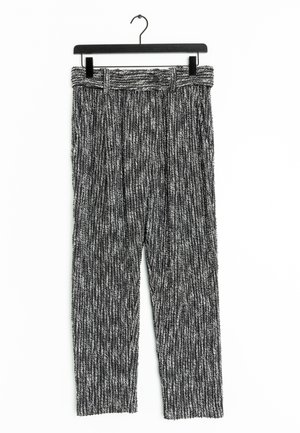 Textured black and white striped trousers with a wide waistband, belt loops, and a straight fit, displayed on a black hanger.
