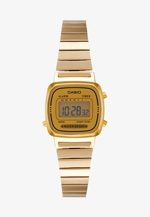 Goldenes digitales Armbanduhr mit quadratischem Zifferblatt, LCD-Anzeige und wasserfestem Merkmal. Metallarmband mit polierter Oberfläche. CASIO-Branding sichtbar.