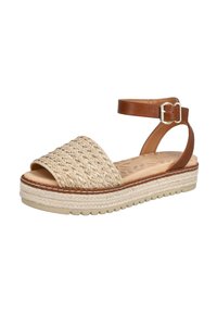 Parte superior de paja tejida con una correa de cuero marrón en el tobillo, suela de plataforma con detalles de yute y un diseño de puntera abierta y redondeada.