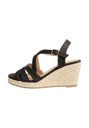 Black wedge sandals made of suede with a jute-wrapped heel. Features adjustable ankle strap and cross-strap design.