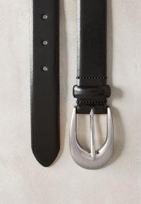 Črni usnjeni pas s gladko teksturo, opremljen s petimi luknjami za prilagajanje in srebrno kovinsko sponko z zaobljeno obliko.