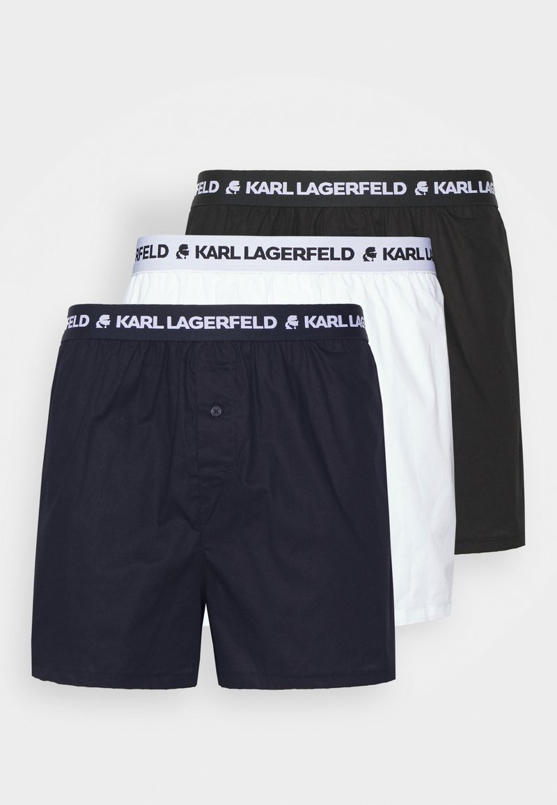 Tamsiai mėlyni, balti ir juodi bokseriai. Pagaminti iš lygios medžiagos, su elastinga juostos detalė, ant kurios yra "KARL LAGERFELD" logotipas. Priekyje yra mygtukas.