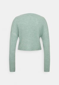 Sweater cropped em verde menta com mangas longas, textura canelada e decote redondo. As costas apresentam um detalhe de costura sutil.
