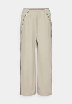 Beige, lightweight trousers with an elastic waist, side pockets, and contrasting black seam detailing. Straight-leg design, smooth texture.