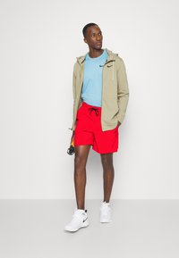 Nike Performance UNLIMITED - Träningsshorts - university red/black