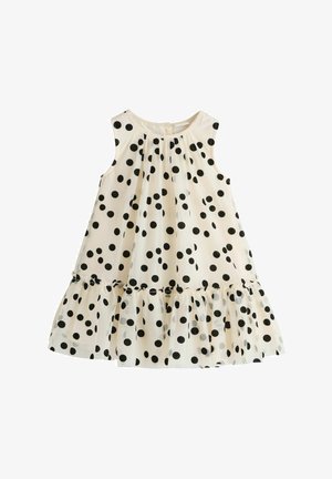 Rochie albă fără mâneci, cu buline negre, decolteu rotund, talie adunată și tiv evazat cu volane.