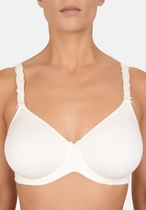 Reggiseno color avorio chiaro realizzato in tessuto morbido, con spalline bordate in pizzo e un piccolo fiocco al centro. Design modellato e senza cuciture.