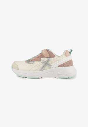 Sneaker with a cream perforated upper, pink suede accents, silver details, adjustable velcro strap, and a white-foam sole with mint green trim.