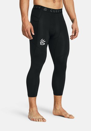 Leggings neri a compressione con branding CURRY sulla vita. Presentano cuciture imbottite e un design elegante e aderente.