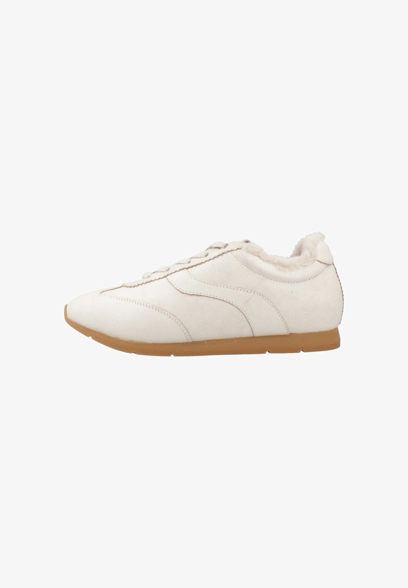 White suede sneakers with a rubber sole, textured laces, and a fluffy interior lining, featuring curved stitching and a sleek, streamlined design.