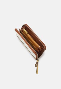 Brown leather wallet with white accent, zip closure, multiple compartments, and a textured finish. Features gold hardware and a wrist strap.