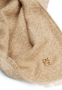 Beige sál, domború geometriai mintával, rojtos széllel és arany színű kiemelésekkel. Puha tapintás és elegáns dizájn.