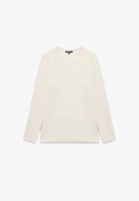 Långärmad topp i off-white tyg, med rund halsringning, avslappnad passform och sidofickor i nederkant för ökad rörelsefrihet.