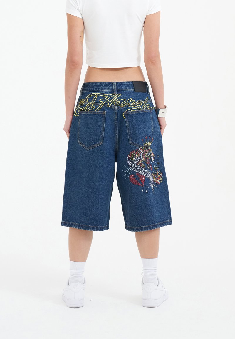 Denim bermuda shorts with a wide leg, featuring yellow "Ed Hardy" embroidery on the back and an embroidered design with a heart and tiger.