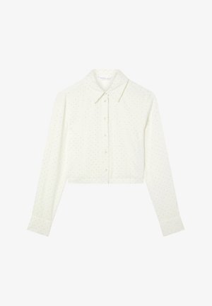 Blusa cropped a maniche lunghe color crema con colletto alla francese, decorata con piccole pois dorate, realizzata in un tessuto morbido.