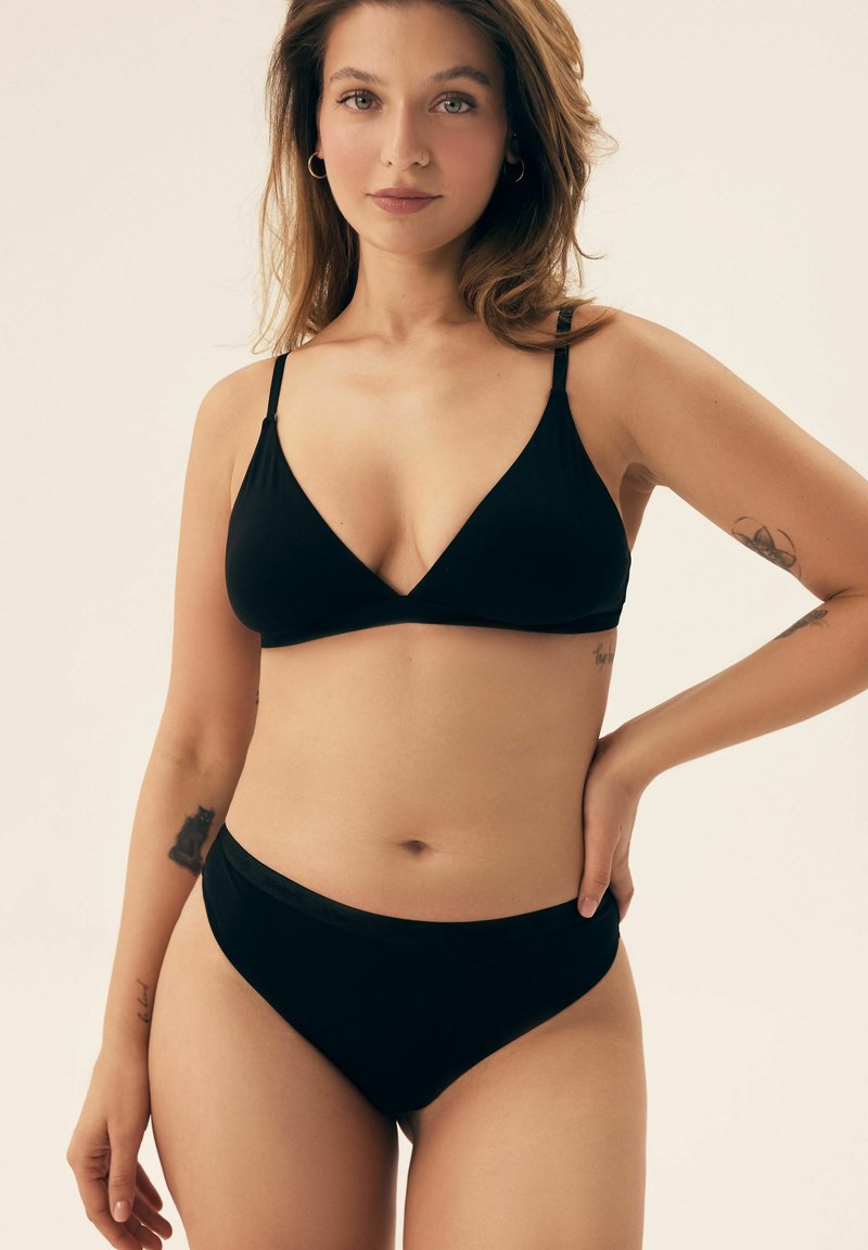 Black bikini set featuring a triangular bralette with slim straps and low-rise briefs, made of soft, smooth fabric with minimal seams.