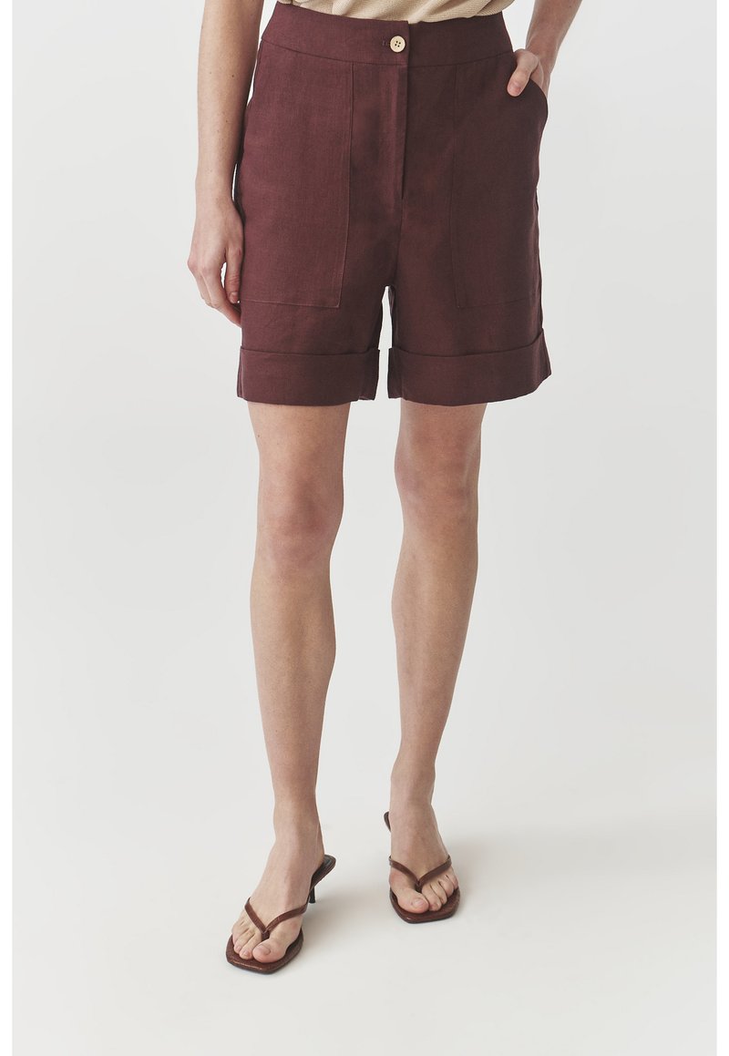 Burgundy linen shorts with two front pockets, cuffed hems, and a single button closure. Lightweight fabric with a smooth texture.