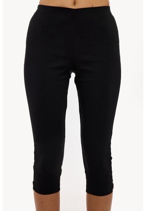 Leggings capri negros con una textura suave y cinturilla elástica. Presentan un diseño ajustado con dobladillos acampanados. Aptos para uso casual.
