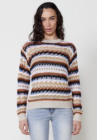 Knit sweater featuring multicolored horizontal stripes in brown, blue, white, and tan, with a textured, open stitch pattern and ribbed hem.