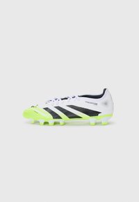 White synthetic soccer cleat with black stripes and a bright green outsole. Features textured detail and a rounded toe for performance.