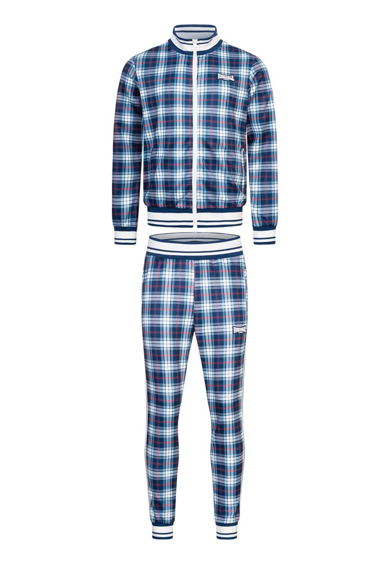 Karo-Sportanzug mit Reißverschlussjacke und schmal zulaufenden Hosen in Marineblau, Weiß und Rot. Der Stoff hat eine glatte Oberfläche; gerippte Bündchen und Säume.