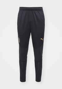 Black athletic pants with a textured fabric, elastic waistband, gold logos, and mesh accents on the lower legs for ventilation.