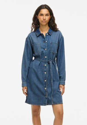 Denim shirt dress with long sleeves, button-down front, two chest pockets, waist tie, and a slightly flared skirt. Dark blue color.