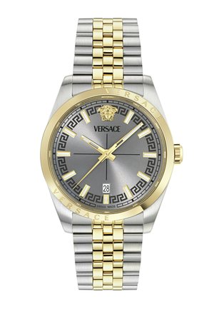 Hõbedane ja kuldne Versace käekell halli sihverplaadiga, kuldsete tundmarkeritega, kuupäeva näidikuga kell 6 ning Medusa logoga kell 12.