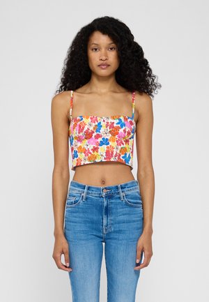 Top court à fleurs avec un imprimé multicolore, décolleté carré et fines bretelles. Assorti à un jean taille haute bleu clair.