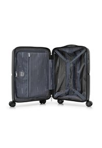 Black hardshell suitcase with four wheels, zippered compartments, and elastic cross straps inside. Lined with a grey fabric featuring diagonal stripes.