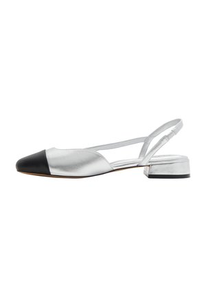 Silver low-heeled slingback shoe with black pointed toe and thin strap against white background.