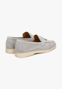 Gray suede loafers with a rounded toe, subtle stitching details, and a cream-colored rubber sole. Slip-on design with no visible hardware.