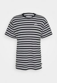 Black and white striped t-shirt made of cotton, featuring a crew neck, short sleeves, and a small Nike logo on the left chest.