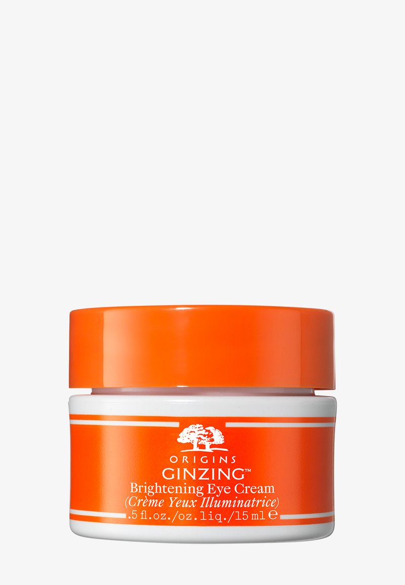 Crème éclaircissante pour les yeux dans un pot circulaire blanc avec un couvercle orange. Présente une étiquette avec le nom du produit et les détails de volume en texte blanc.
