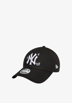 Black baseball cap with white embroidered New York Yankees logo and small blue butterflies, made of fabric with a structured shape and curved visor.