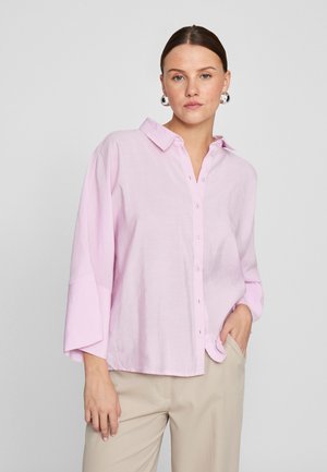 Light pink button-up shirt in a relaxed fit with a collar and wide sleeves, made from a soft, slightly textured fabric.