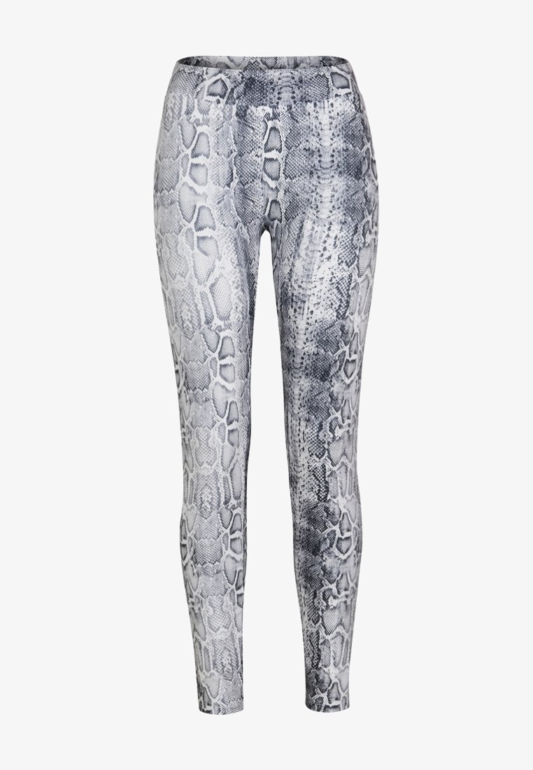 Leggings imprimés serpent en noir et blanc, avec une texture lisse et un design ajusté, dotés d'une taille haute et d'une finition à motifs.