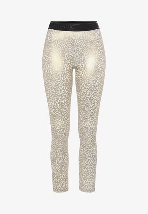 Leggings in einem hellbeigen Farbton mit einem Leopardenmuster und einer glänzenden Gold-Oberfläche. Schwarzer elastischer Bund mit "ATHLETIC"-Markenaufschrift.